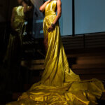 Evening gown fashion editorial photographed with dramatic directional lighting.