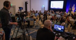 James Patrick Photography and LUMEDIA Creative production team filming keynote presentations during Troon's 2026 Fusion Forum conference in Tucson, Arizona using professional Sony cinema cameras for corporate event video production.