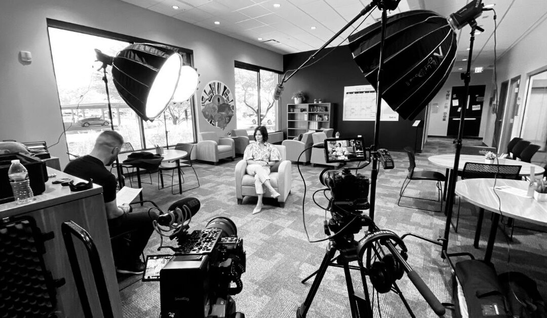 Behind the scenes of a brand photoshoot showing a professional photographer creating strategic brand images for a business marketing campaign