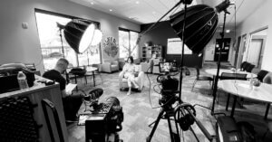 Behind the scenes of a brand photoshoot showing a professional photographer creating strategic brand images for a business marketing campaign