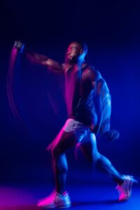 OHM Fitness male athlete with colorful motion light streaks in Phoenix commercial photography