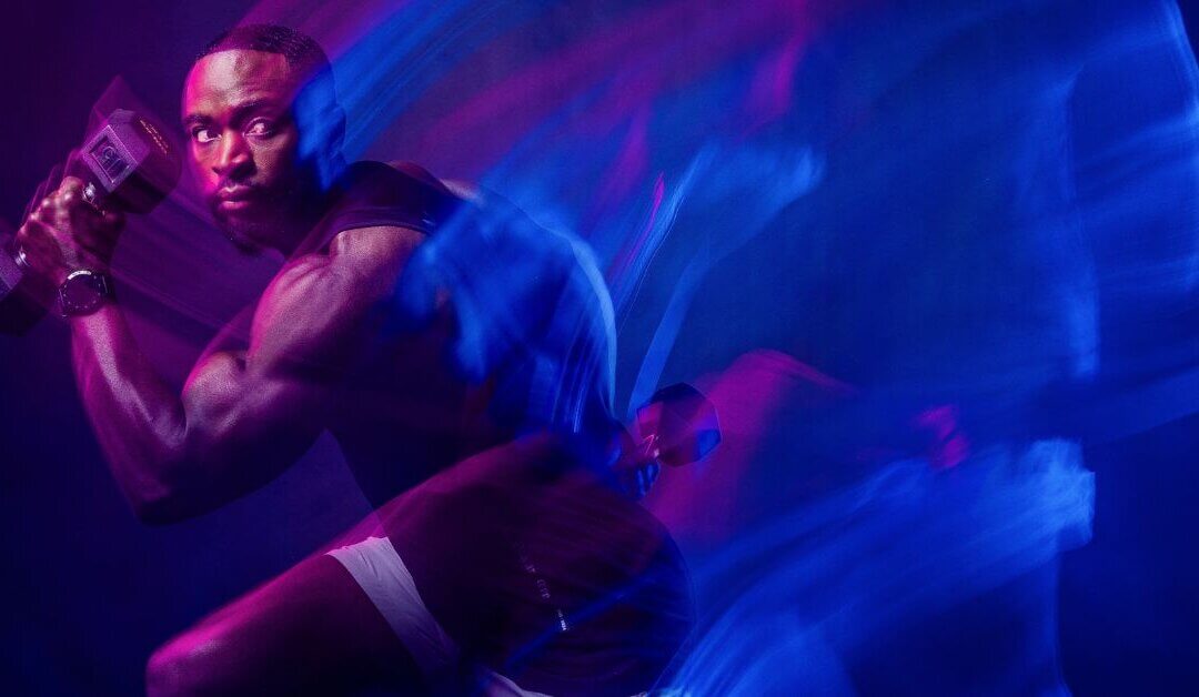 OHM Fitness athlete photographed with colorful motion light streaks during a Phoenix commercial photography production